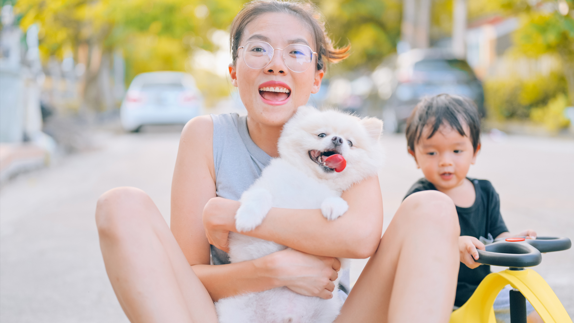 mom playing with son & pet dog